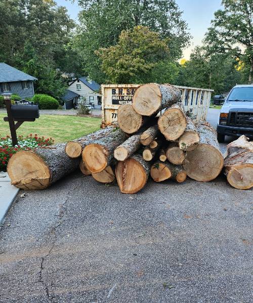 A pile of wood sitting on the side of a road