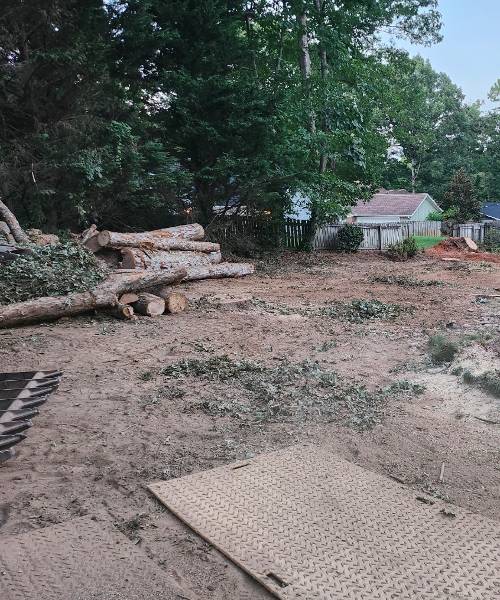 A pile of wood sitting in the middle of a yard